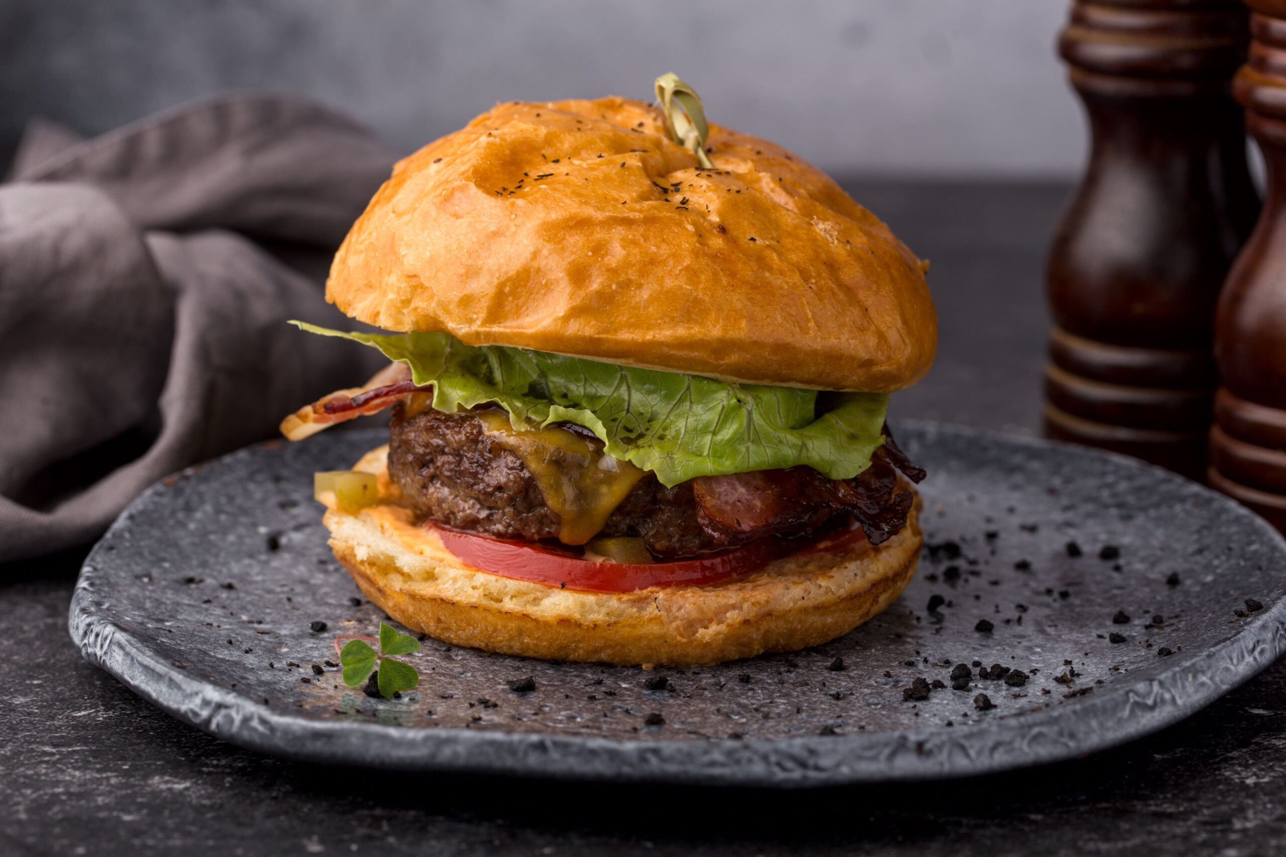 meat-burger-with-lettuce-bacon-tomato-on-a-plate-2024-10-11-15-18-51-utc-min